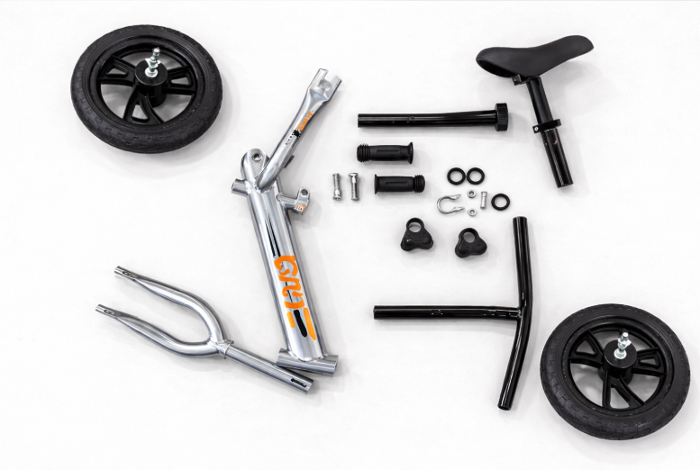 Balance bike parts layout before assembly – frame, wheels, fork, handlebars and seat UK