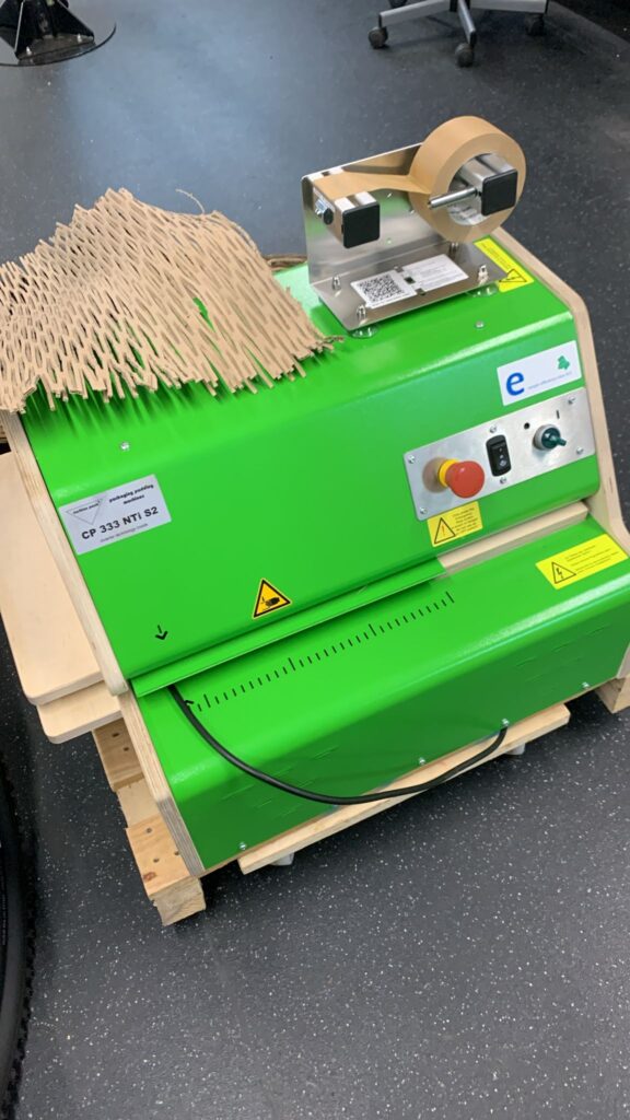 Honeycomb kraft paper packaging machine preparing recyclable protective wrapping for bicycles before UK delivery