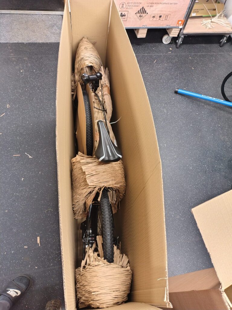 Black Bike bicycle securely packed inside shipping box with eco friendly honeycomb protective packaging for UK delivery